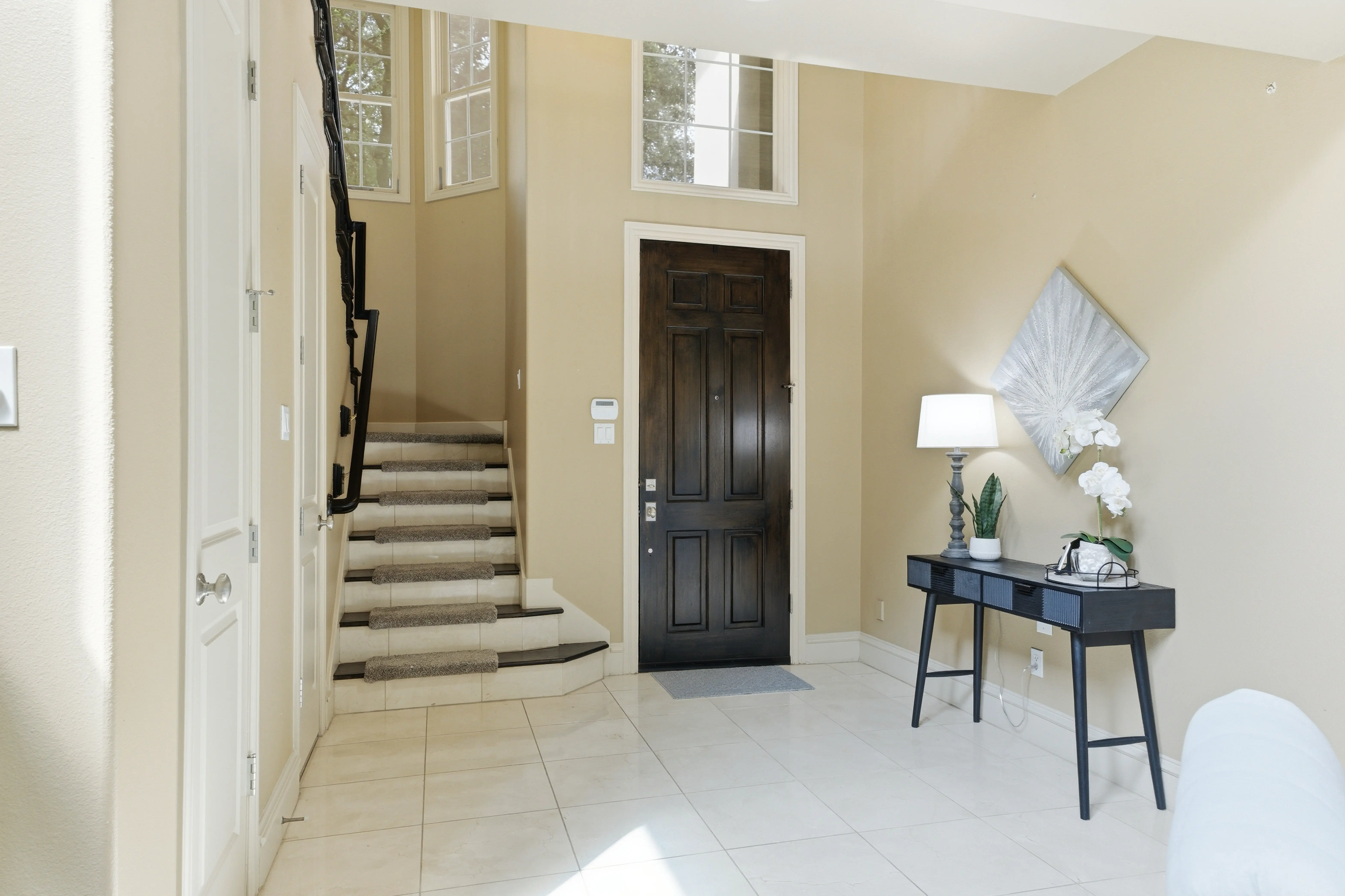 Foyer entry with staircase and iron railing