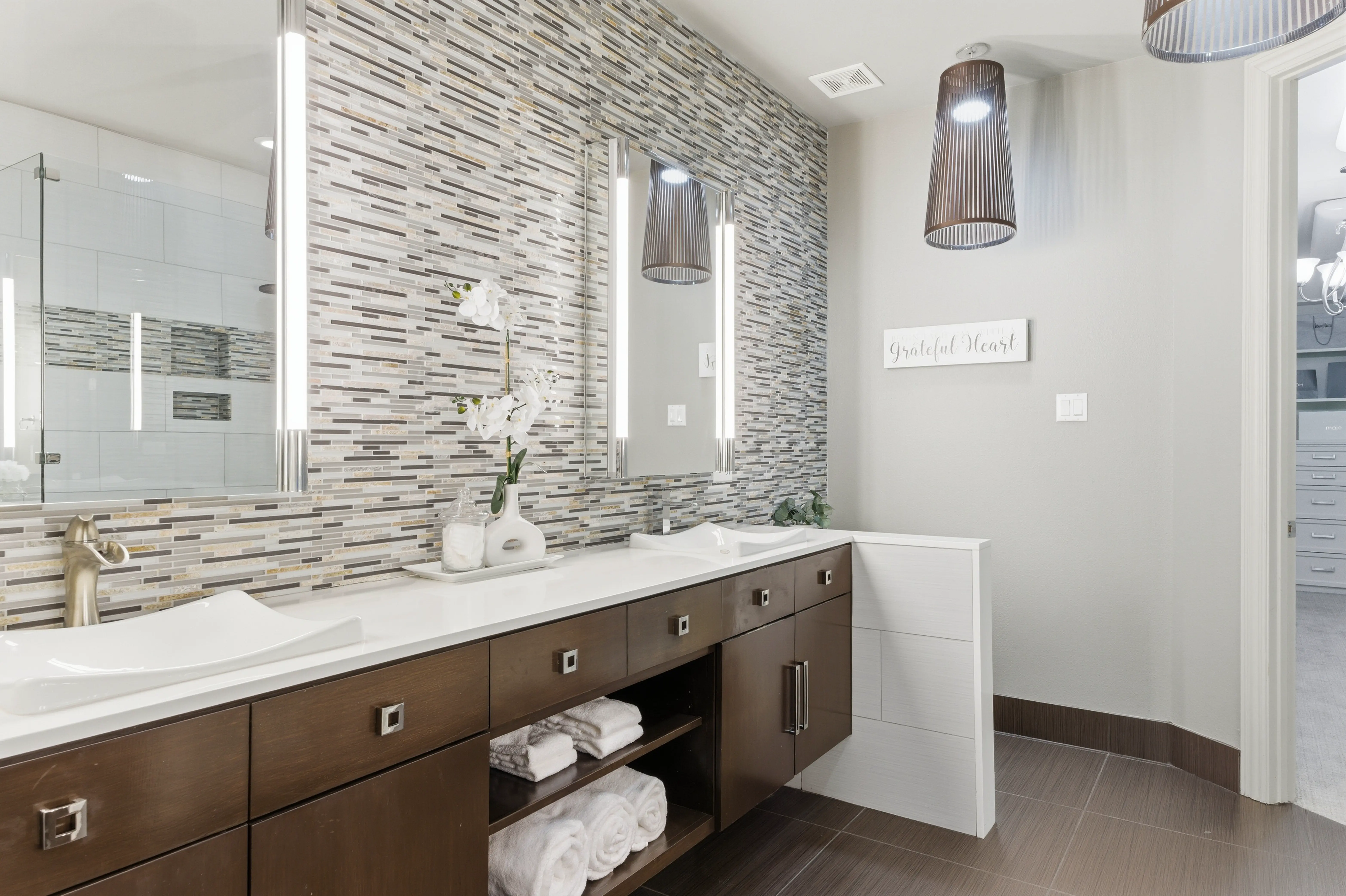 Primary bathroom with dual vanity and mosaic tile