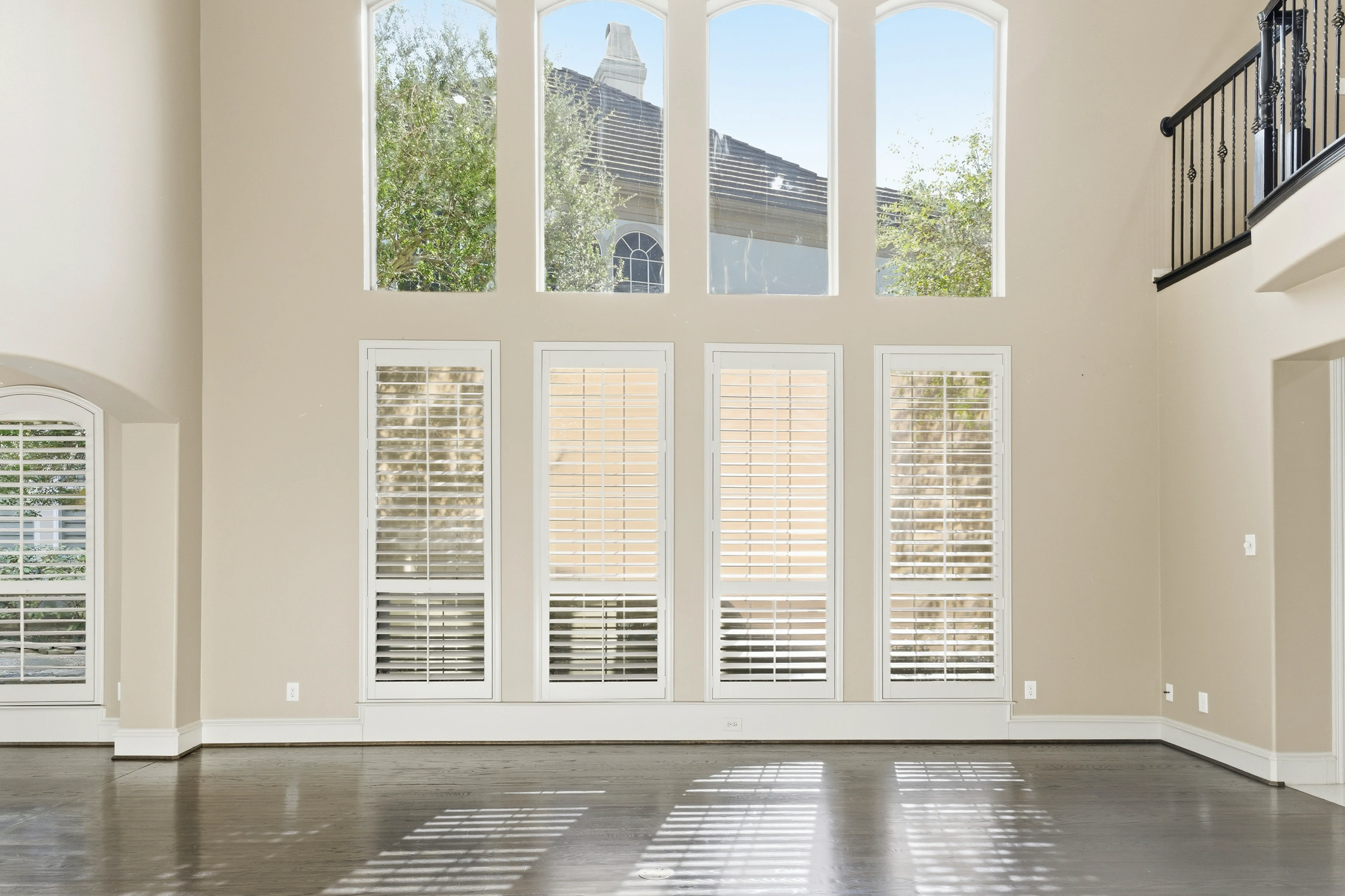 Kitchen with gas cooktop, granite countertops, and white cabinetry